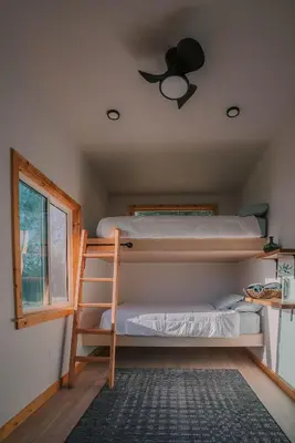 a bedroom with two bunk beds and a ceiling fan at Off-Grid Tiny Home Pacific Views & Serenity in Pauma Valley