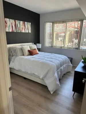 a bedroom with a large bed with a large window at Stylish Gaslamp 1BR Den Patio Walk Everywhere in San Diego