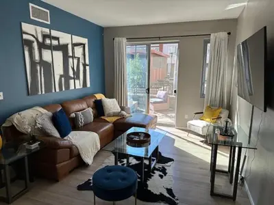 a living room with a couch and a table at Stylish Gaslamp 1BR Den Patio Walk Everywhere in San Diego