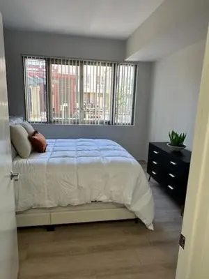 a bedroom with a bed and two windows at Stylish Gaslamp 1BR Den Patio Walk Everywhere in San Diego