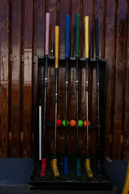 a bunch of baseball bats lined up against a wall at Family Pool House Oasis in National City