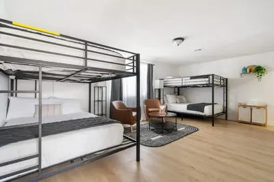 a bedroom with two bunk beds and a desk at Family Pool House Oasis in National City