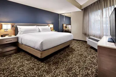 a bedroom with a large bed and a blue wall at Hilton Garden Inn San Diego Mission Valley/Stadium in San Diego