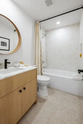 a bathroom with a sink and a toilet and a tub at Marina Dream - Lagoon Views in Carlsbad