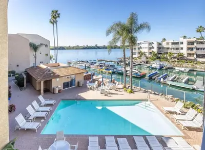 an overhead view of a pool with chairs and a marina at Marina Dream - Lagoon Views in Carlsbad