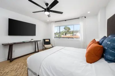 a bedroom with a bed and a flat screen tv at Marina Dream - Lagoon Views in Carlsbad