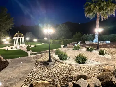 a park at night with a gazebo and a palm tree at San Diego French Garden Poolside Retreat - Wine Country & Safari Park in Escondido