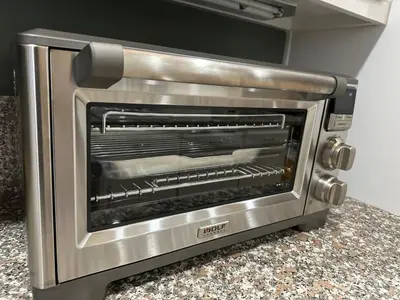 a silver toaster oven sitting on top of a counter at San Diego French Garden Poolside Retreat - Wine Country & Safari Park in Escondido