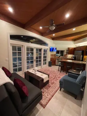 a living room with a couch and a table at San Diego French Garden Poolside Retreat - Wine Country & Safari Park in Escondido