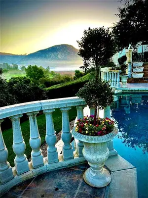 a white railing with a vase with flowers on it at San Diego French Garden Poolside Retreat - Wine Country & Safari Park in Escondido