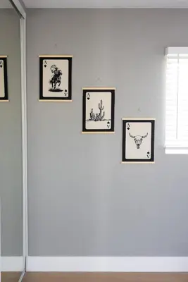 four framed pictures on a white wall at The Urban Den by Coastline Vacation Rentals in San Diego
