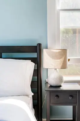a bedroom with a bed and a table with a lamp at Skyline Vista by Coastline Vacation Rentals in San Diego