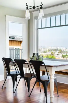 a dining room with a table and chairs and a window at Skyline Vista by Coastline Vacation Rentals in San Diego
