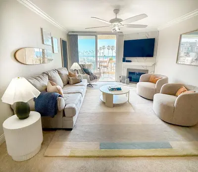 a living room with a couch and a table at Panoramic Ocean View Beachfront Condo in Oceanside