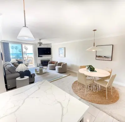 a living room with a table and chairs at Panoramic Ocean View Beachfront Condo in Oceanside