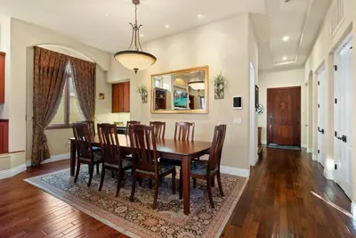 a dining room with a wooden table and chairs at Tuscan Sands by Coastline Vacation Rentals in San Diego