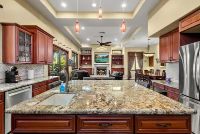 a kitchen with a large island in the middle at Tuscan Sands by Coastline Vacation Rentals in San Diego