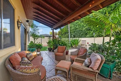 an outdoor patio with couches and chairs and plants at Tuscan Sands by Coastline Vacation Rentals in San Diego