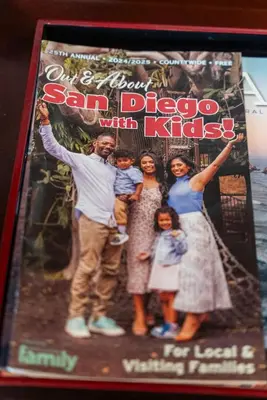a magazine with a picture of a family at Tuscan Sands by Coastline Vacation Rentals in San Diego