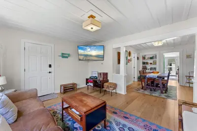 a living room with a couch and a table at Lotus House by Coastline Vacation Rentals in San Diego