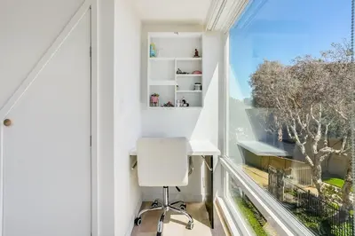 a white desk and chair in a room with a window at Luxury Beachfront Townhouse with Breathtaking Views in Solana Beach