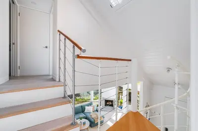 a room with a spiral staircase in a house at Luxury Beachfront Townhouse with Breathtaking Views in Solana Beach