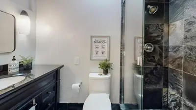 a bathroom with a toilet and a sink and a shower at The Clubhouse by Coastline Vacation Rentals in San Diego