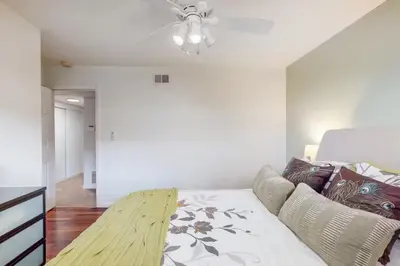 a bedroom with a bed and a ceiling fan at The Clubhouse by Coastline Vacation Rentals in San Diego