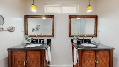 a bathroom with two sinks and a mirror at The Clubhouse by Coastline Vacation Rentals in San Diego