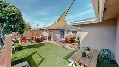 a small backyard with a table and a lawn at The Clubhouse by Coastline Vacation Rentals in San Diego