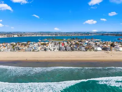 an aerial view of a beach with condos at The Surf Shack by Coastline Vacation Rentals in San Diego
