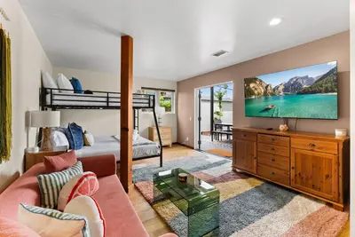 a living room with a couch and a tv at Nomad Surf Lounge by Coastline Vacation Rentals in San Diego