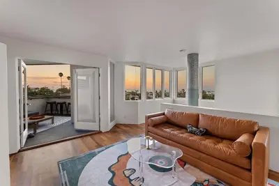 a living room with a couch and a table at Nomad Surf Lounge by Coastline Vacation Rentals in San Diego
