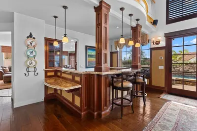 a kitchen with a large island with bar stools at Carmel Valley Villa by Coastline Vacation Rentals in San Diego