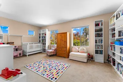 a childs room with a crib and book shelves at Carmel Valley Villa by Coastline Vacation Rentals in San Diego