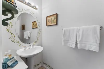 a white bathroom with a sink and a mirror at Carmel Valley Villa by Coastline Vacation Rentals in San Diego