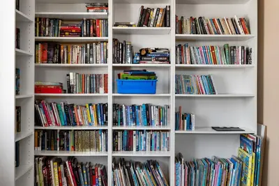 a book shelf filled with lots of books at Carmel Valley Villa by Coastline Vacation Rentals in San Diego