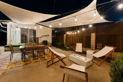 a patio with a table and chairs and lights at The Wave by Coastline Vacation Rentals in San Diego