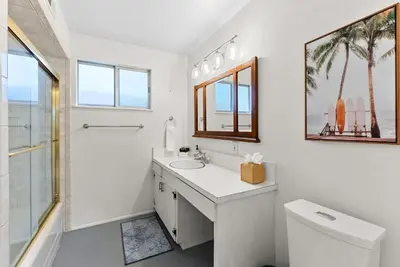 a white bathroom with a sink and a toilet at The Wave by Coastline Vacation Rentals in San Diego