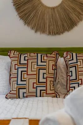 a bed with two pillows and a head board at The Wave by Coastline Vacation Rentals in San Diego
