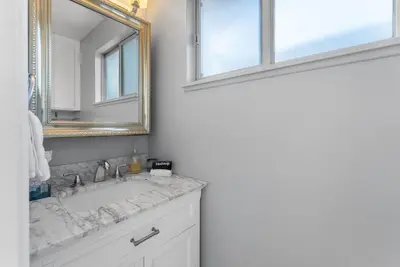 a bathroom with a sink and a mirror at The Wave by Coastline Vacation Rentals in San Diego