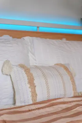 a white pillow sitting on top of a bed at The Wave by Coastline Vacation Rentals in San Diego
