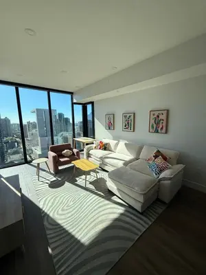 a living room with two couches and a table at Little Italy, close to everything in San Diego