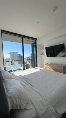 a bedroom with a large bed and a large window at Little Italy, close to everything in San Diego
