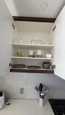 a kitchen with plates and utensils sitting on shelves at Little Italy, close to everything in San Diego