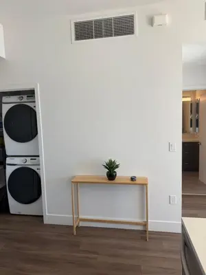 a living room with a table and a wall at Little Italy, close to everything in San Diego