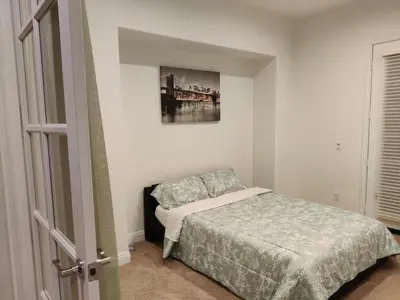 a bedroom with a bed and a painting on the wall at Beautiful Villa with Amazing 360 Mountain Views, Golfcourses close to Monserate Winery and I-15 in Fallbrook