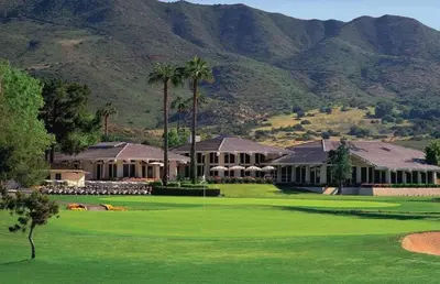 a golf course with a house and mountains in the background at Beautiful Villa with Amazing 360 Mountain Views, Golfcourses close to Monserate Winery and I-15 in Fallbrook