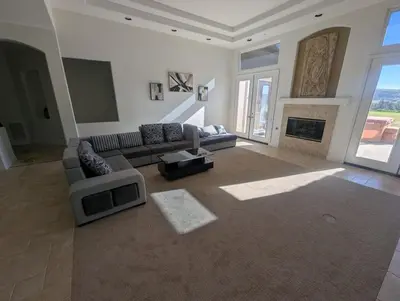 a large living room with a couch and a fireplace at Beautiful Villa with Amazing 360 Mountain Views, Golfcourses close to Monserate Winery and I-15 in Fallbrook
