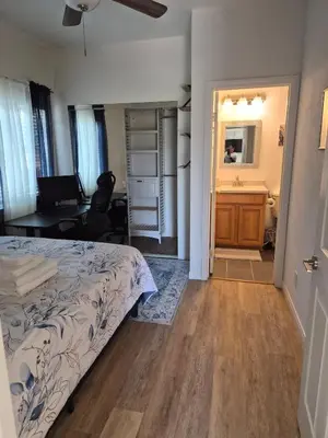 a bedroom with a bed and a desk and a desk at Amazing Guest House near Monserate Winery with 360 Mountain Views in Fallbrook